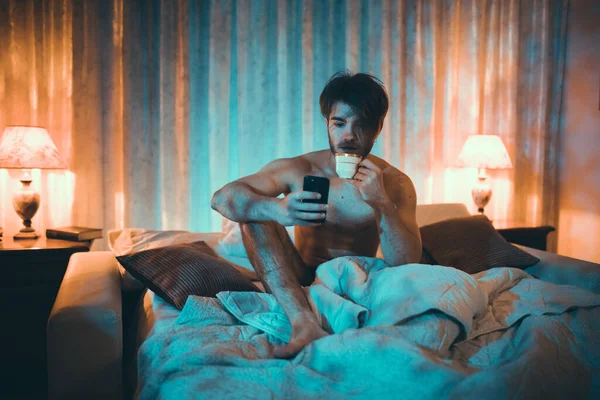 Portrait Young Man Using Phone Bad Home Interior — Stok Foto