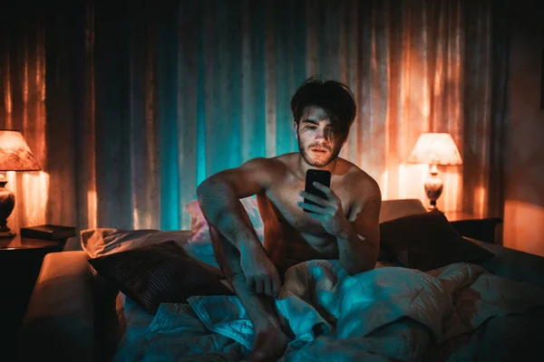 Portrait Young Man Using Phone Bad Home Interior — Stok Foto