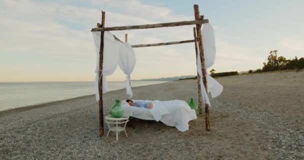 Young Girl Blue Shirt Sleeps Canopy Bed Ocean Beach Sunrise — Vídeo de Stock