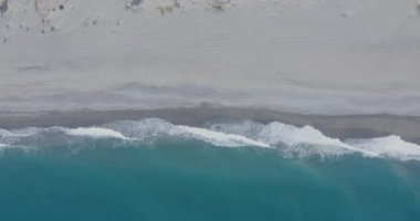Aerial view of sandy beach and wavy sea at daytime, Italy 