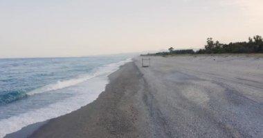 Aerial view of sandy beach and wavy sea at daytime, Italy 