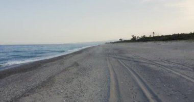 Aerial view of sandy beach and wavy sea at daytime, Italy 