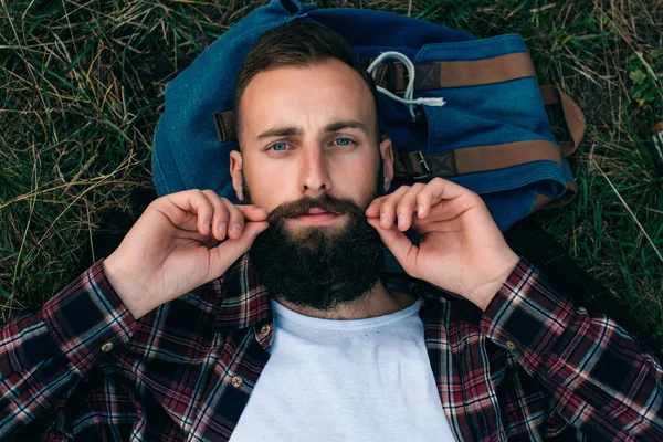 Bearded Man lying on the grass Stock Photo