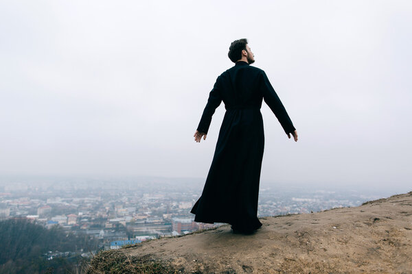 portrait of handsome catholic bearded priest