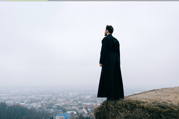 portrait of handsome catholic bearded priest