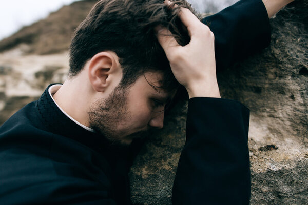 portrait of handsome catholic bearded priest