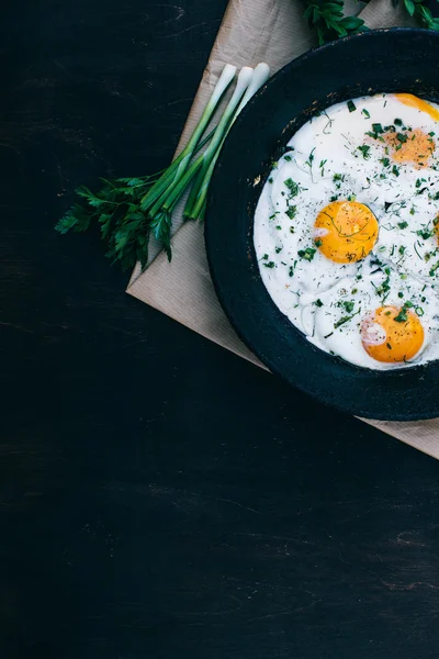 Fried eggs in cast iron frying pan — Stock Photo, Image