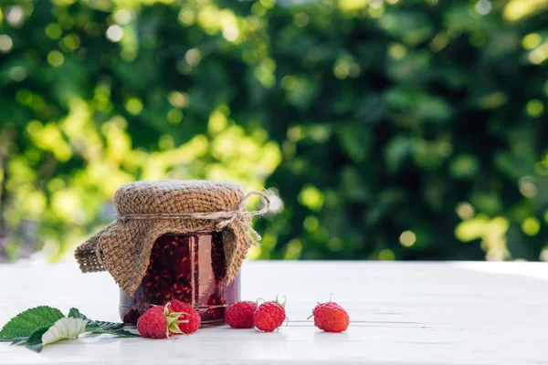 Raspberry jam in a jar on the wooden table — Stock Photo, Image