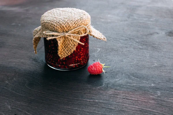 Raspberry jam in a jar on the wooden table — Stock Photo, Image