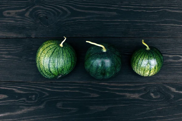 Small watermelon full put on wood table — Stock Photo, Image