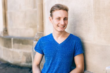 Çekici mavi gözlü, sarışın genç adam sokakta