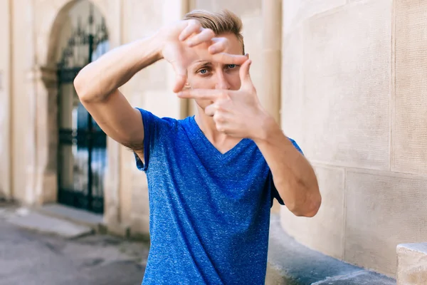 Attractive blue eyed, blond young man on the street — Stock Photo, Image