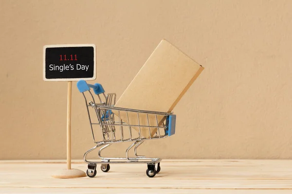 Online shopping of China, 11.11 single\'s day sale concept. The box in shopping cart and  text 11.11 single\'s day sale with copy space.