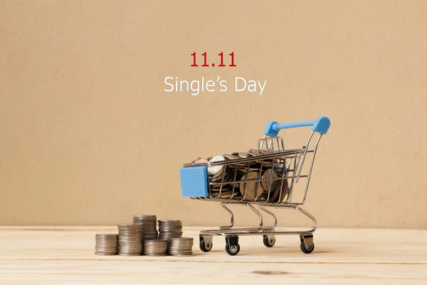 Online shopping of China, 11.11 single\'s day sale concept. The coin in shopping cart and the text 11.11 single\'s day sale.
