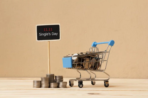 Online shopping of China, 11.11 single\'s day sale concept. The coin in shopping cart and the text 11.11 single\'s day sale.