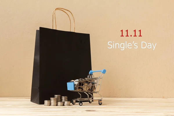 Online shopping of China, 11.11 single\'s day sale concept. The coin in shopping cart ,bag shopping and text 11.11 single\'s day sale with copy space.