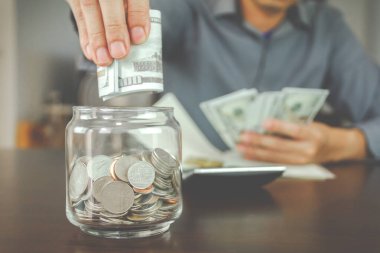 Yatırım ve tasarruf konsepti. İş adamı sahte parayı cama koyuyor.