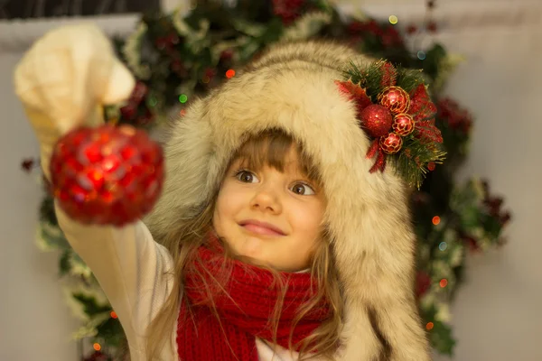 Girl fur hat Christmas wreath — Stock Photo, Image