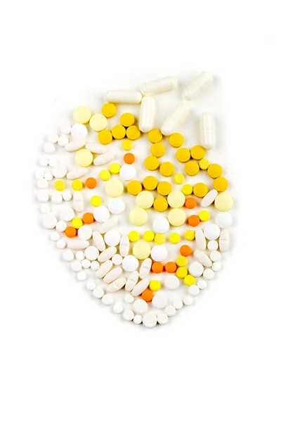 Tablets on a white background in white, yellow, orange syringe w — 图库照片