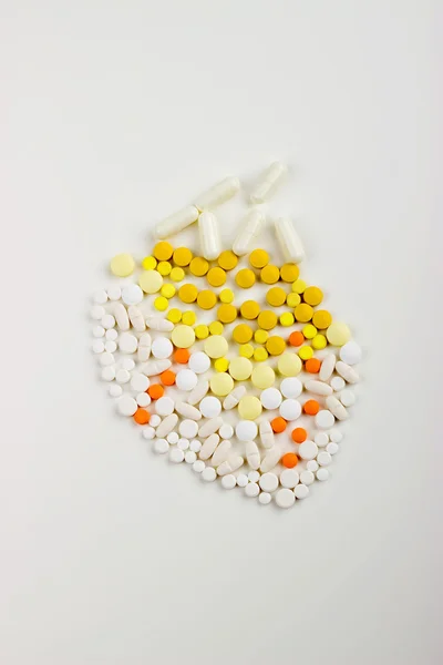 Tablets on a white background in white, yellow, orange syringe w — Stok fotoğraf