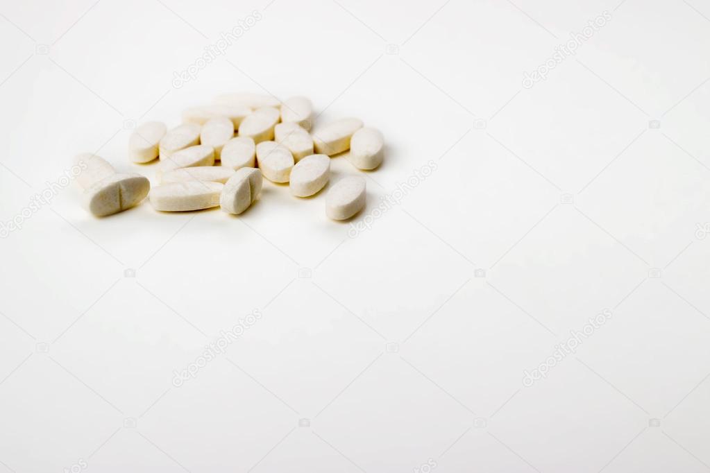tablets on a white background in white, yellow, orange, a syring