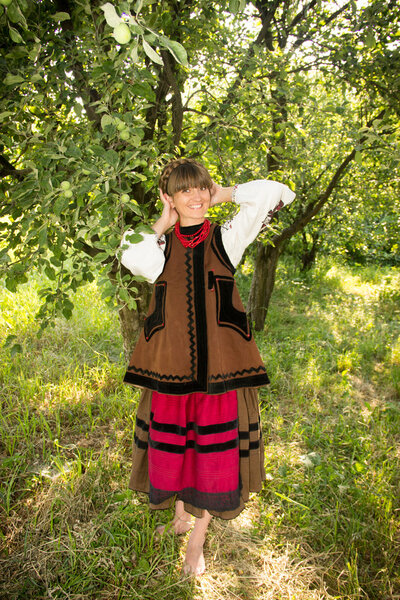 young girl, Ukrainian national costume, standing barefoot on the