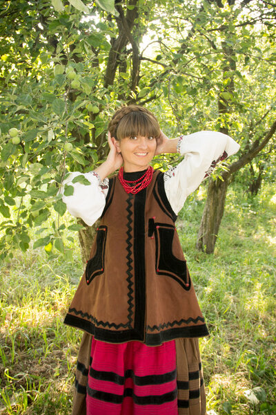 young girl, Ukrainian national costume, standing barefoot on the