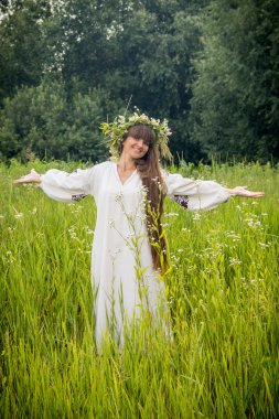 young girl in the Ukrainian embroidered shirt, with a wreath of 