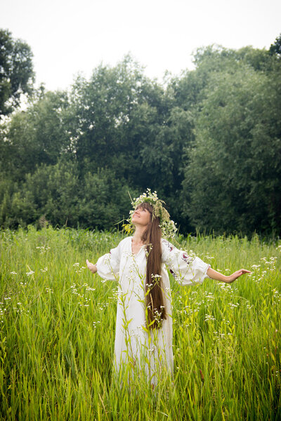 young girl in the Ukrainian embroidered shirt, with a wreath of 