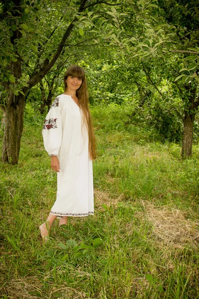 Young girl in the Ukrainian embroidered shirt, standing barefoot — Stock Photo, Image