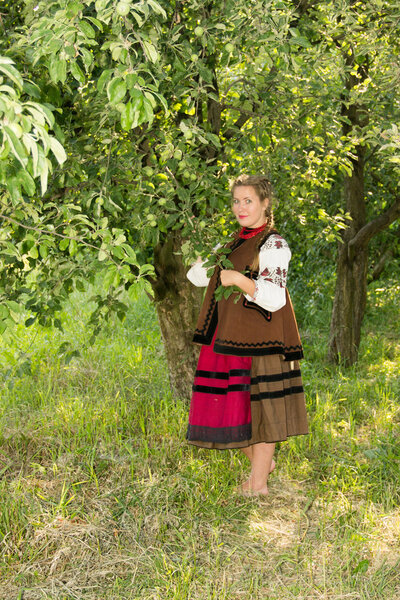 young girl, Ukrainian national costume, standing barefoot on the