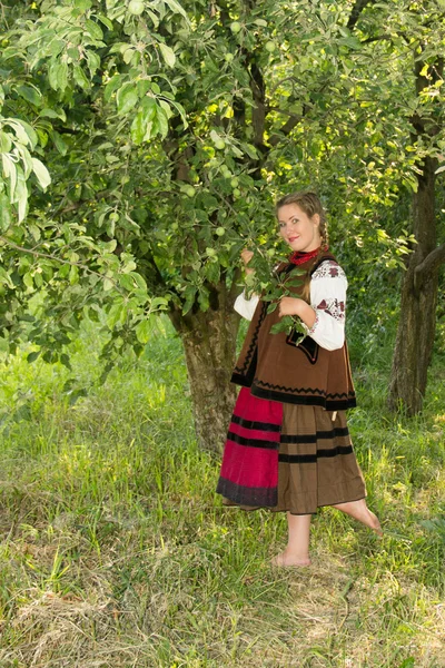 Young girl, Ukrainian national costume, standing barefoot on the — 스톡 사진