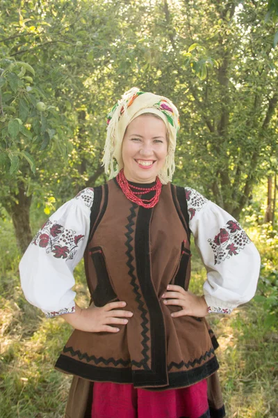 Young girl, Ukrainian national costume, standing barefoot on the — стокове фото