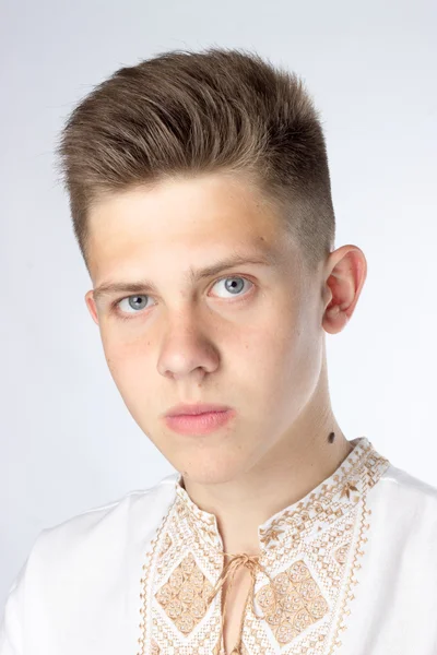 A young man, a student, brunette, gray eyes, white shirt — Stock Photo, Image