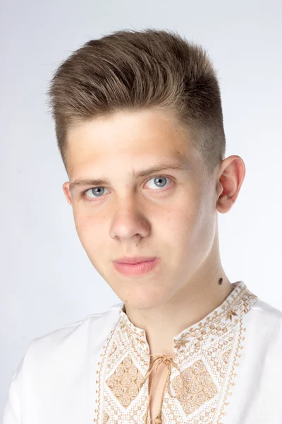 A young man, a student, brunette, gray eyes, white shirt — Stock Photo, Image