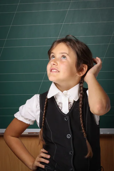 Girl schoolgirl in a black school uniform, a white shirt with tw — Stock Photo, Image