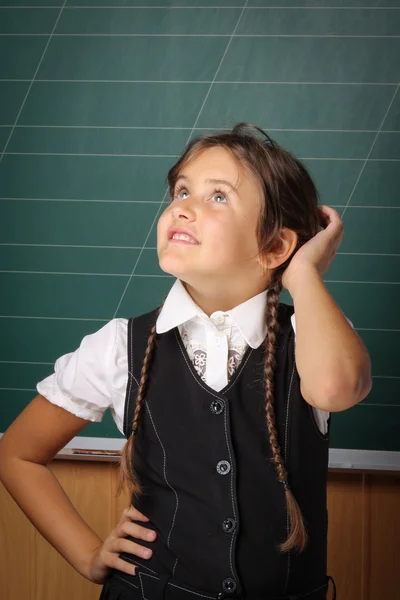 Girl schoolgirl in a black school uniform, a white shirt with tw — Stock Photo, Image