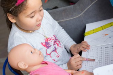 Evde dool öğreten güzel bir Kazak kızı. Evde eğitim