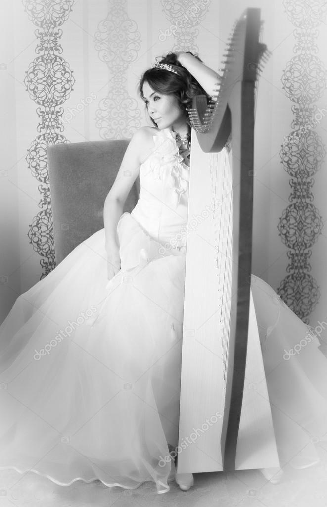 Beautiful asian bride with harp