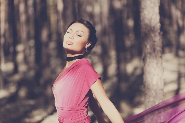 Beautiful kazakh woman in trendy dress in the forest — Stock Photo, Image