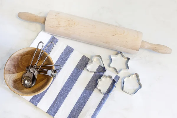 Baking tools cookies cutter and measuring spoons — Stock Photo, Image