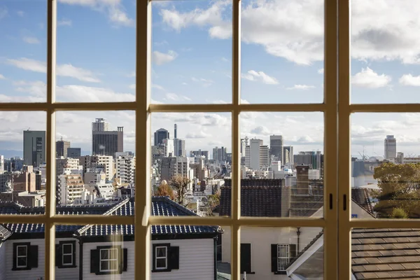 City view through window with blue sky and cloud — Stock Photo, Image