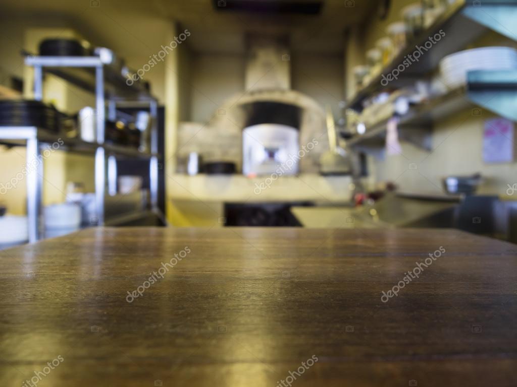 Restaurant Kitchen Background top of wooden table with blurred kitchen restaurant background Restaurant Kitchen Background top of wooden table with blurred kitchen restaurant background