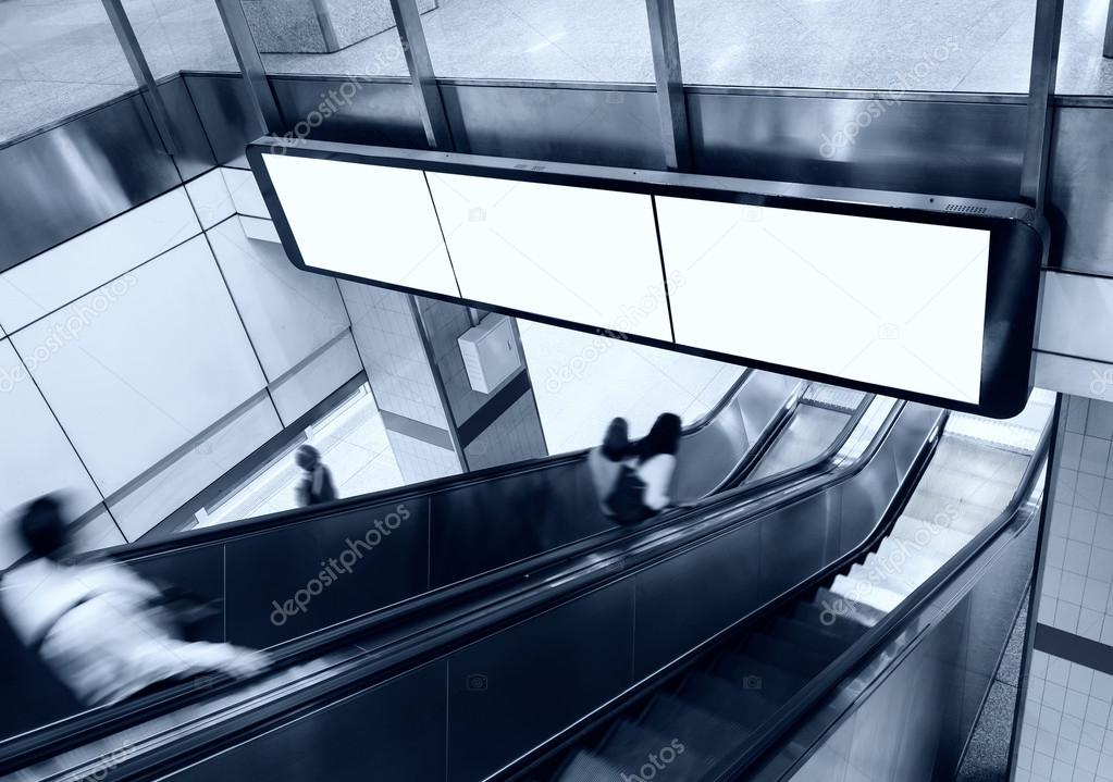 Blank Banner Billboard Display with escalator and people in subway station