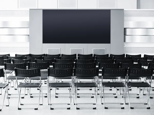 İş toplantı seminer odası konferans koltuklar ve boş ekran