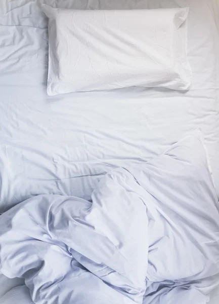 White unmade Bed mattress Duvet with pillow and blanket Top view — Stock Photo, Image