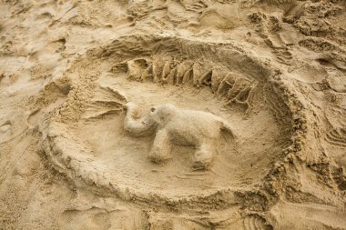 The elephant and the inscription Thailand made in the sand clipart