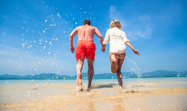 Loving couple on a tropical beach against the sea — Stock Photo, Image