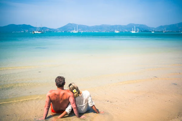 Loving couple on a tropical beach against the sea — Stock Photo, Image