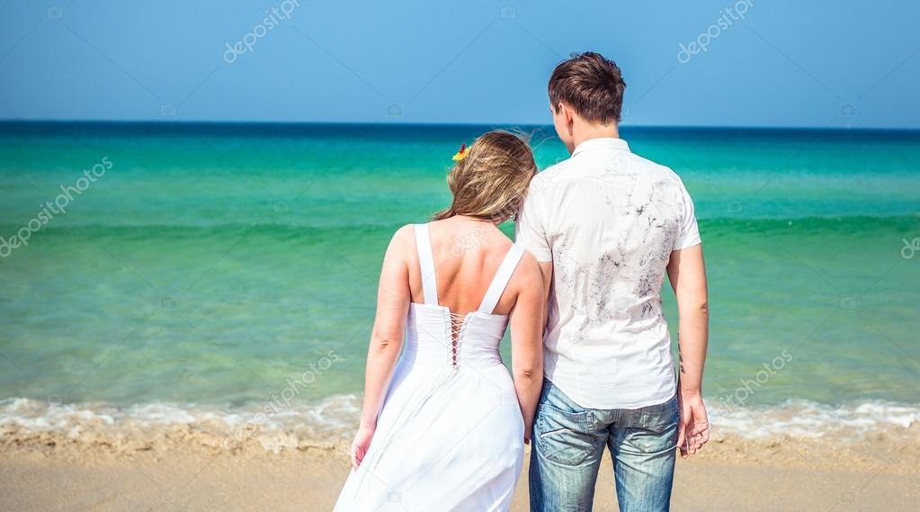 Loving couple on a tropical beach against the sea
